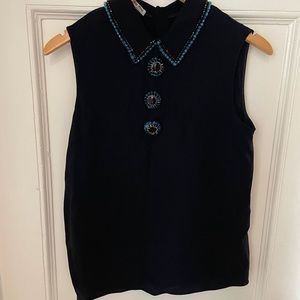 Miu Miu sleeveless black silk top with menswear-inspired beaded embellishments.